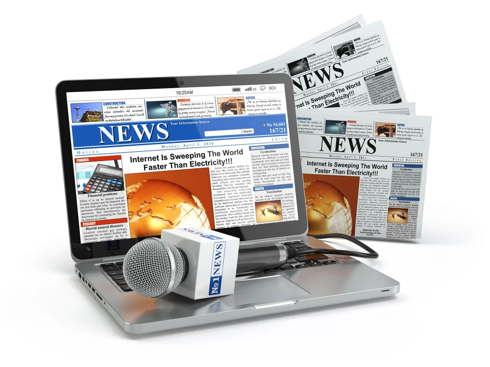 Laptop and newspapers containing a press release
