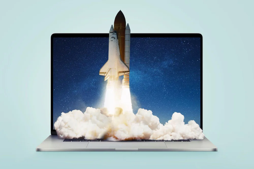 A space shuttle taking off from a laptop illustrating a successful business