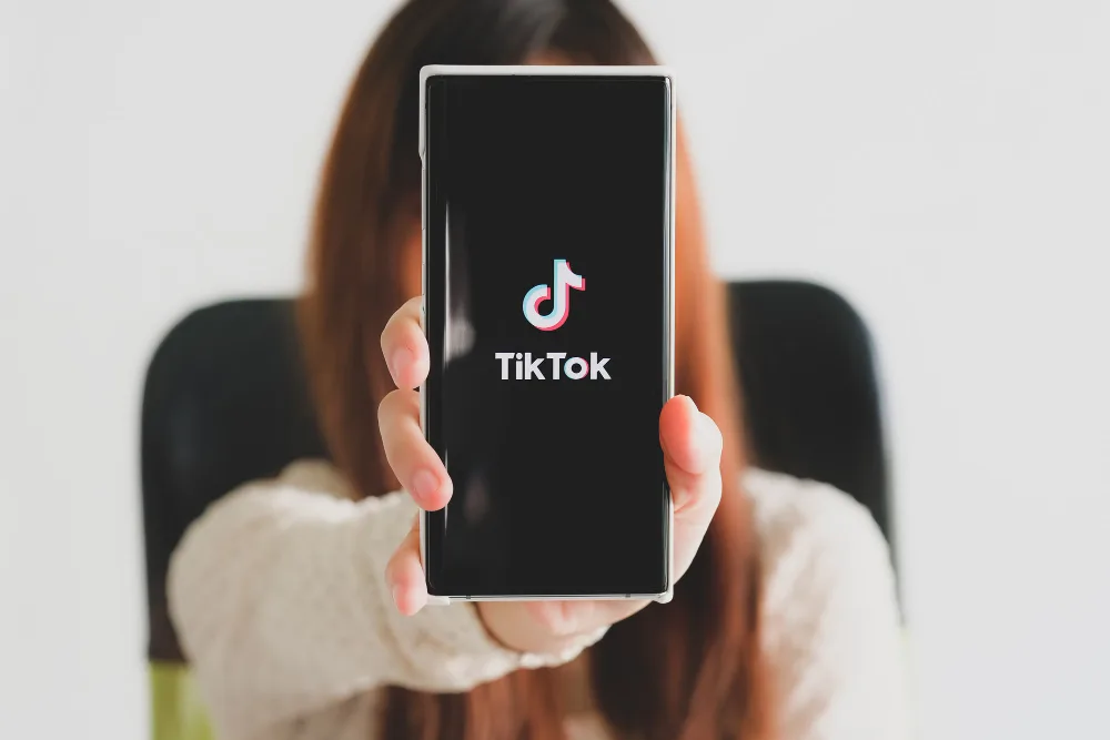 a person doing SEO holding a phone with tiktok